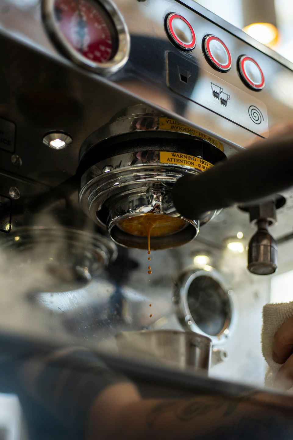 Professionelle Espressomaschine brüht Kaffee mit bernsteinfarbener Flüssigkeit.